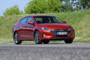 Red Hyundai Elantra driving on road