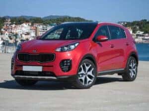 2017 red kia sportage parked by a lake