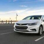 white chevy cruze parked by dock