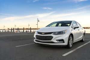 white chevy cruze parked by dock