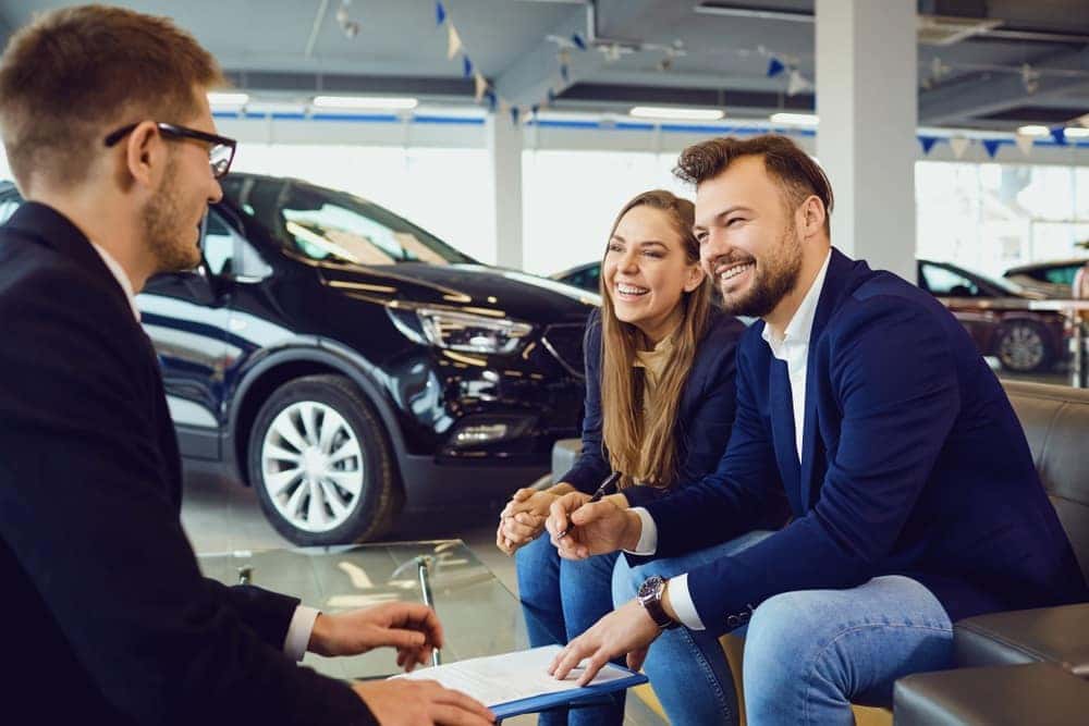 Chevrolet Team member discussing financing options with couple at Finance Center