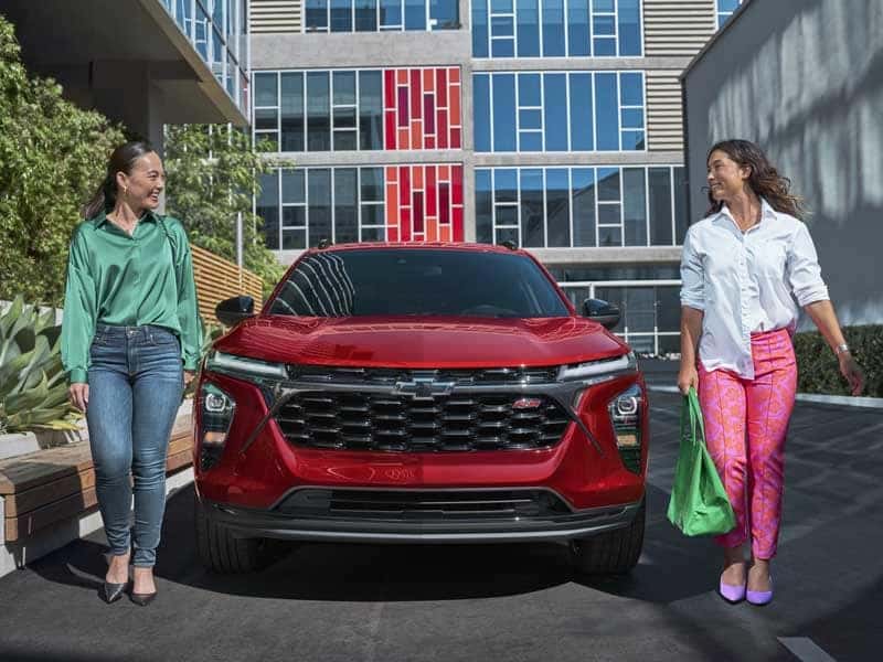 Front View of Chevrolet Trax parked on side of road with two women walking around it from Used Car Dealer near Me