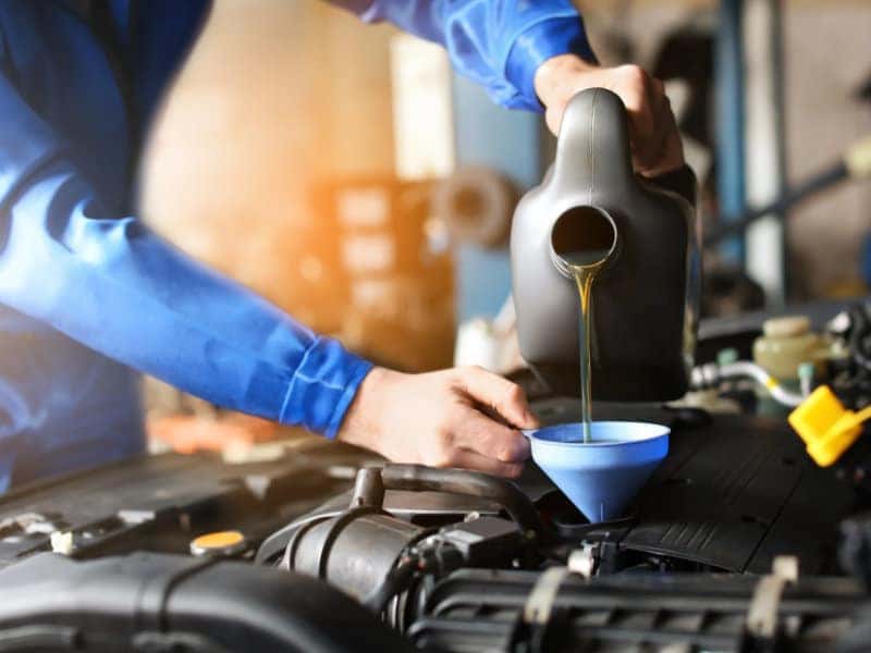 Technician performing an oil change at Blasius Chevrolet