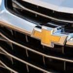 A closeup is shown of the yellow Chevrolet logo on a silver 2020 Chevy Blazer at a Chevy dealer near me in Indianapolis, IN.