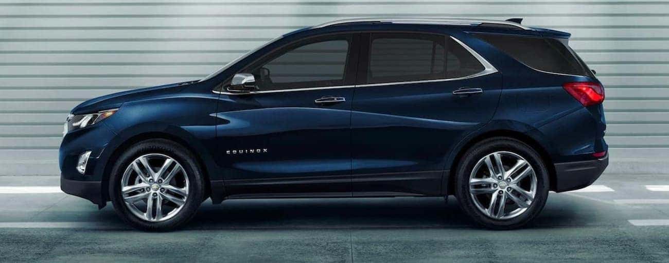 A dark blue 2020 Chevy Equinox is shown from the side in an Indianapolis parking garage.