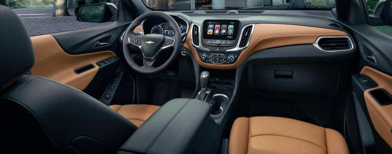 The black and tan interior of a 2020 Chevy Equinox is shown.