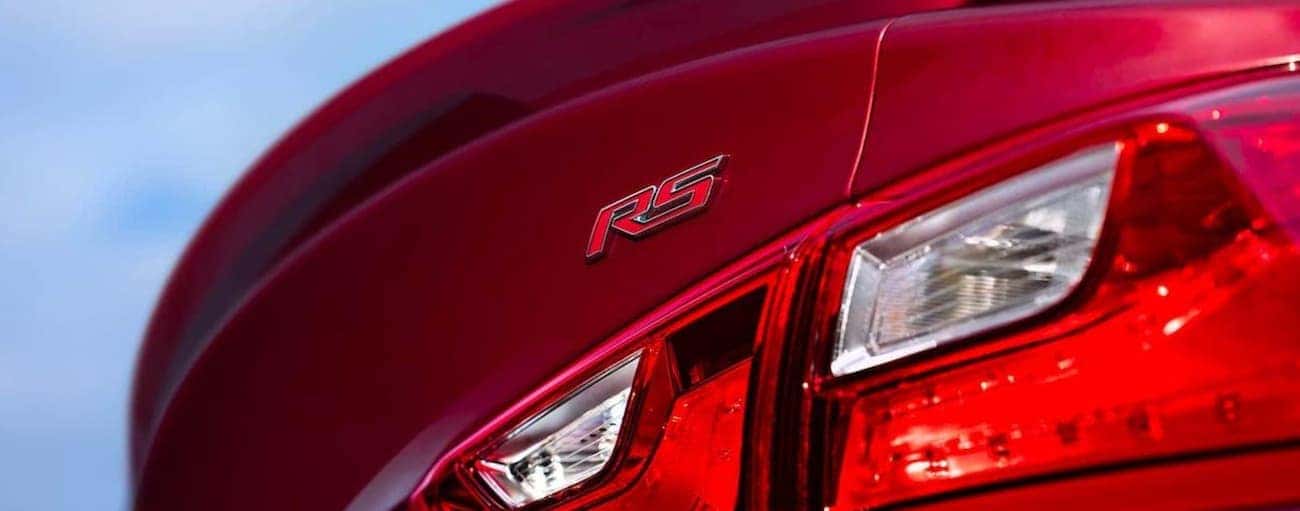 The rear badging on a red 2020 Chevy Malibu RS is shown.