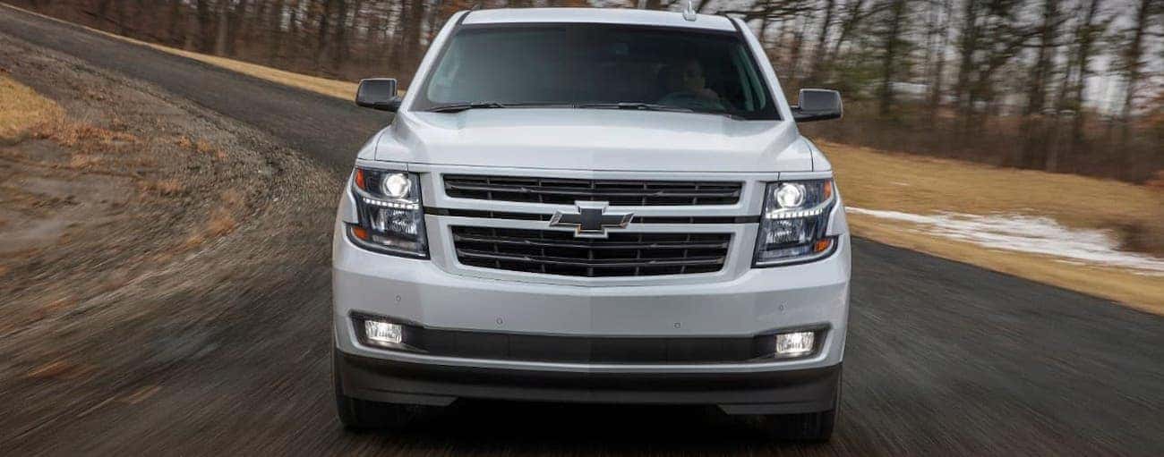 A white 2018 used Chevrolet Tahoe RST is racing around a winding road outside Indianapolis, IN.