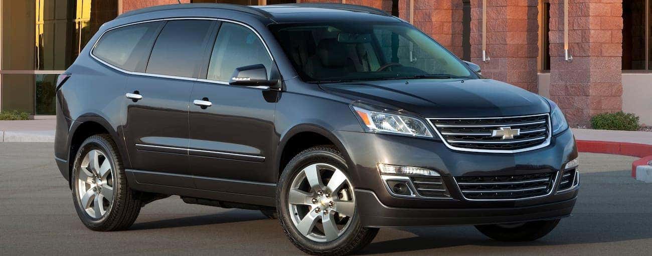 A gray 2017 used Chevrolet Traverse is parked in front of a building near Indianapolis, IN.