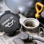 A closeup shows an oil cap on an engine that is removed during an Oil Change Near you around Indianapolis, IN.