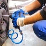 A mechanic is using an impact wrench to change a tire at an Indianapolis tire shop near you.