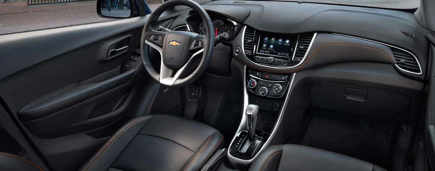 The black front seats with orange stitching are shown in a 2021 Chevy Trax.