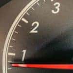 A closeup shows the tire pressure light on the information cluster on a car while being checked out at a tire shop near you.