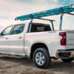 A white 2021 Chevy Silverado 1500 is shown from the side after leaving a commercial vehicle dealer in Indianapolis.