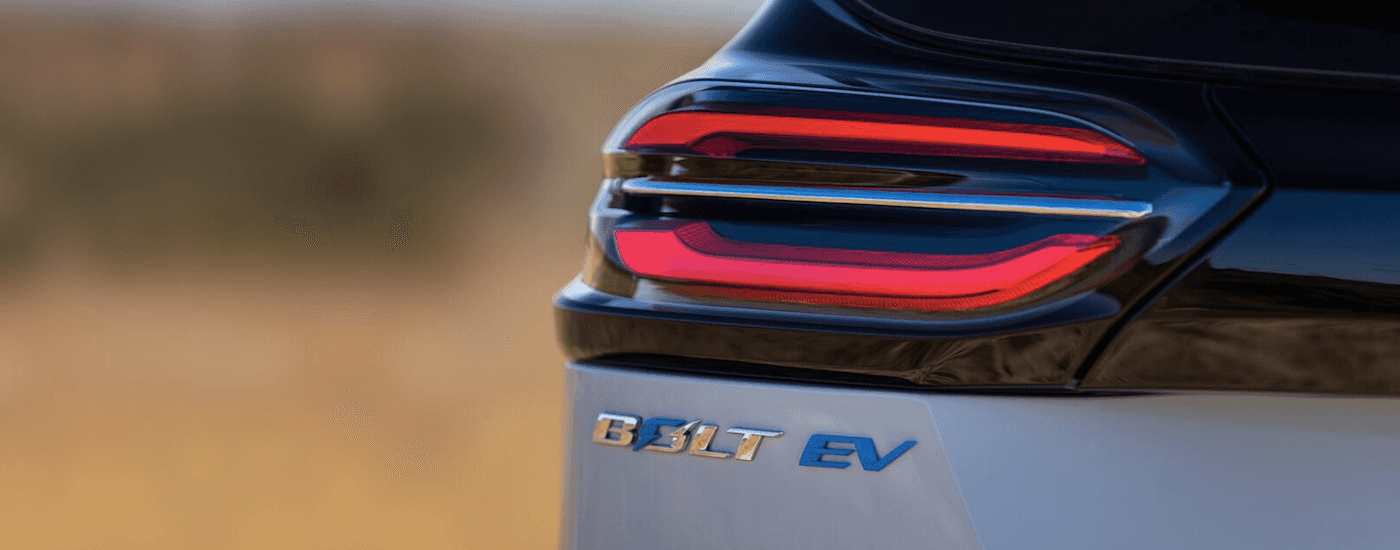 The rear badging on a silver 2022 Chevy Bolt EV is shown.