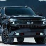 A black 2021 Chevy Silverado 1500 Midnight Edition is parked in a snow covered field after leaving a Chevy truck dealer in Indianapolis.
