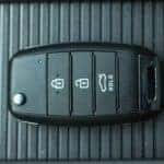 A close up shows a car key.