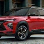 A red 2022 Chevy Trailblazer RS is shown from the side parked on a city street.