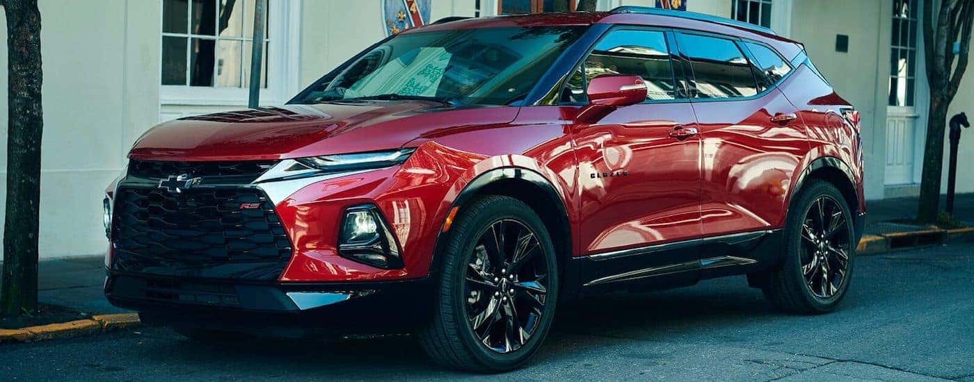 A red 2019 Chevy Blazer RS is shown parked on a city street.