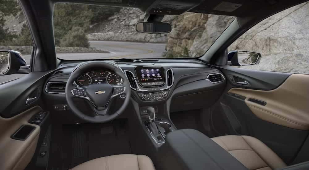 The tan interior of a 2022 Chevy Equinox Premier is shown from the drivers seat.