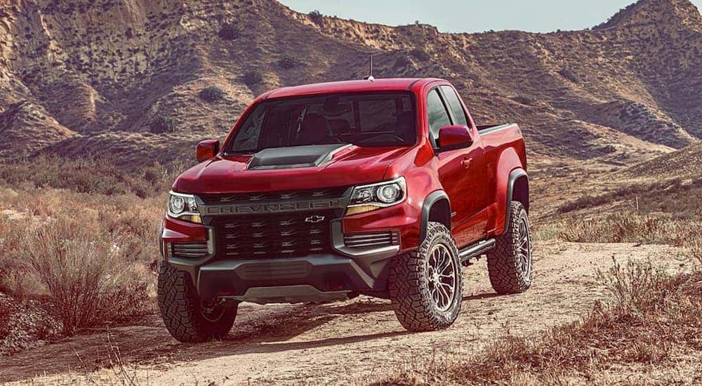 A red 2021 Chevy Colorado ZR2 is shown from the front at an angle while parked offroad.