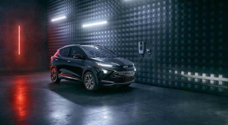 A black 2023 Chevy Bolt EUV Redline Edition is shown parked in a modern warehouse.