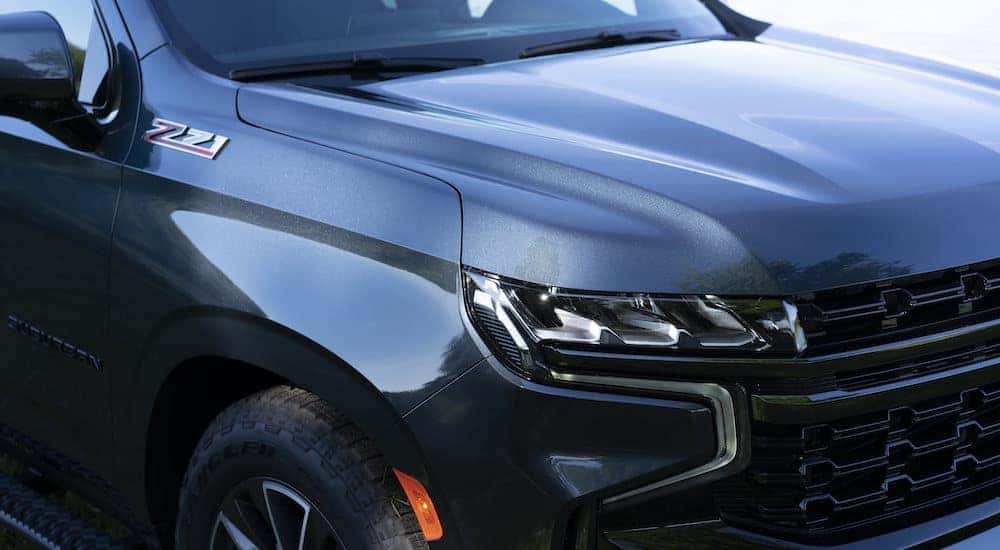 A close up shows the passenger headlight on a silver 2021 Chevy Suburban Z71.