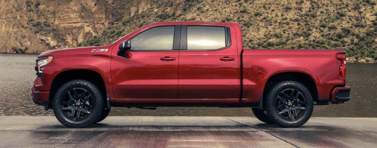 A red 2023 Chevy Silverado 1500 Z71 is shown from the side.