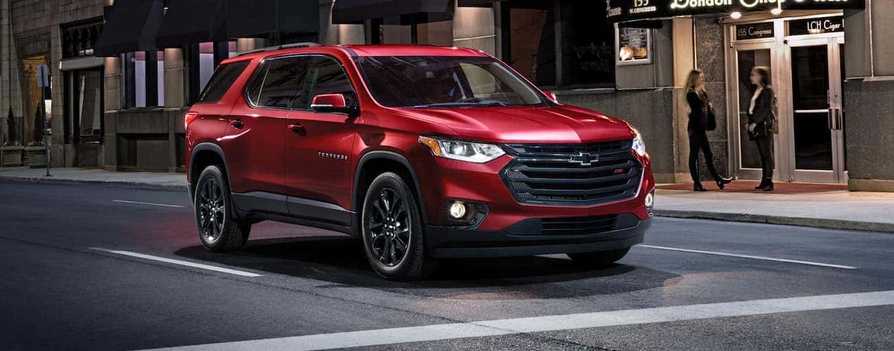A red 2020 Chevy Traverse RS is shown on a city street.