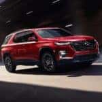 A red 2023 Chevy Traverse RS is shown from the front at an angle after leaving a dealer that has a Chevy Traverse for sale near Greenfield, IN.