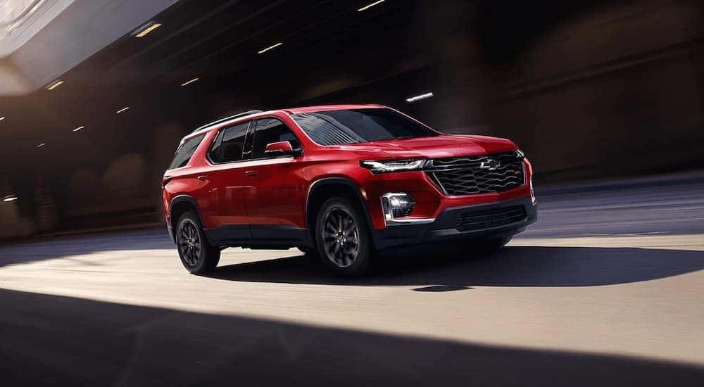 A red 2023 Chevy Traverse RS is shown from the front at an angle after leaving a dealer that has a Chevy Traverse for sale near Greenfield, IN.