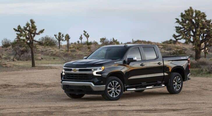 A black 2022 Chevy Silverado LT is shown from the front at an angle.