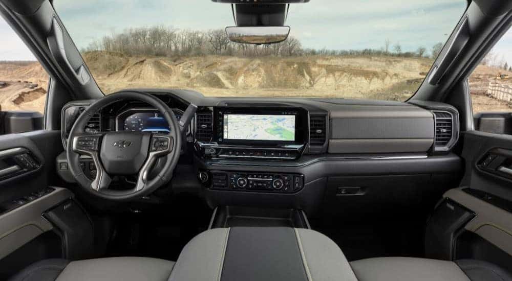 A popular Chevy Silverado for sale, the black and gray interior and dash of a 2024 Chevy Silverado HD ZR2, is shown.