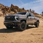 A gray 2024 Chevy Silverado HD ZR2 is shown parked off-road.