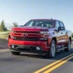 A red 2020 Chevy Silverado 1500 is shown from the front at an angle after leaving a dealer that has a Chevy Silverado for sale near Fishers, IN.