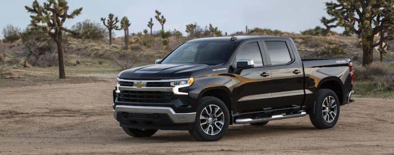 A black 2023 Chevy Silverado 1500 LT is shown from the front at an angle.