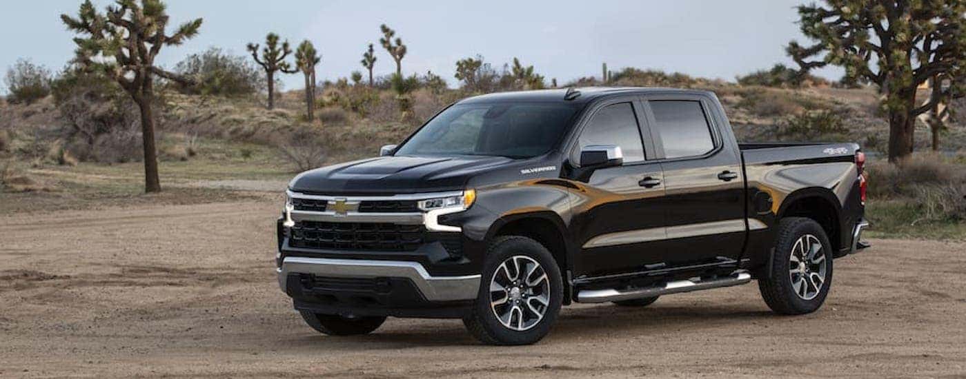 A black 2022 Chevy Silverado 1500 LT is shown from the side.