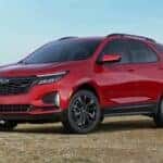 A red 2022 Chevy Equinox RS is shown from the front at an angle after leaving a used car dealership in Indianapolis.