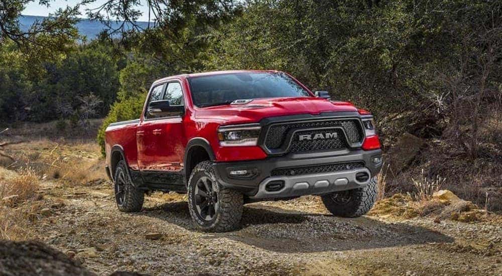 A red 2019 Ram 1500 Classic is shown driving off-road.