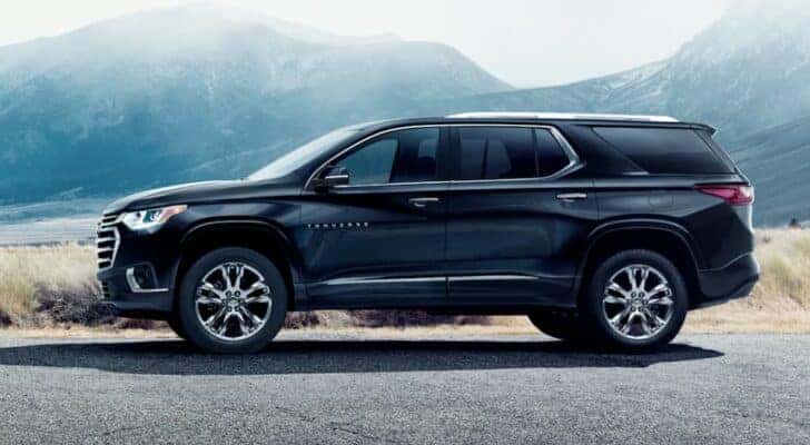 A black 2021 Chevy Traverse is shown parked after visiting a certified pre-owned Chevy dealer.