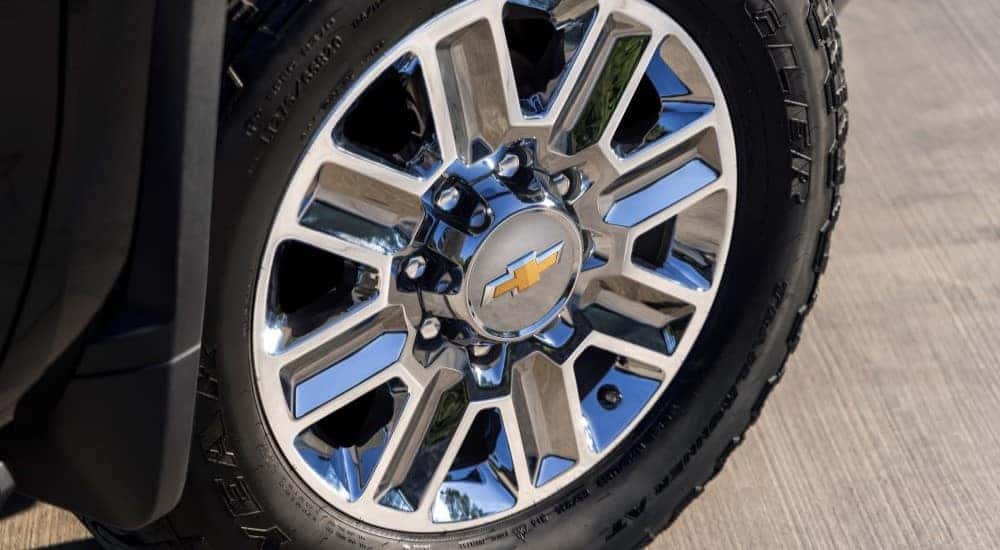 The close-up of a wheel on a 2024 Chevy Silverado HD High Country is shown.