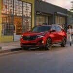 A red 2024 Chevy Equinox is shown parked on a curb after visiting a Indianapolis Chevy dealer.