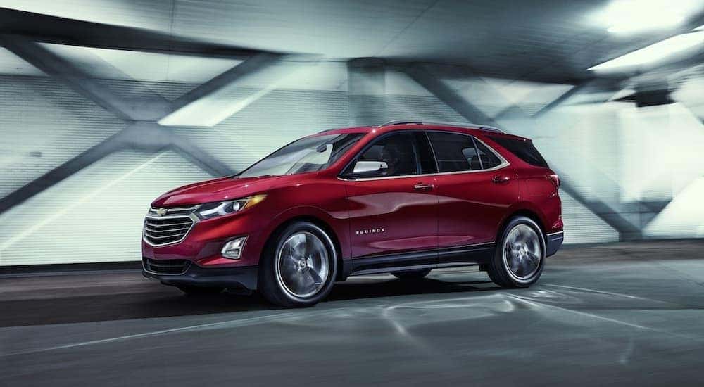 A red 2015 Chevy Equinox is shown driving in a tunnel.