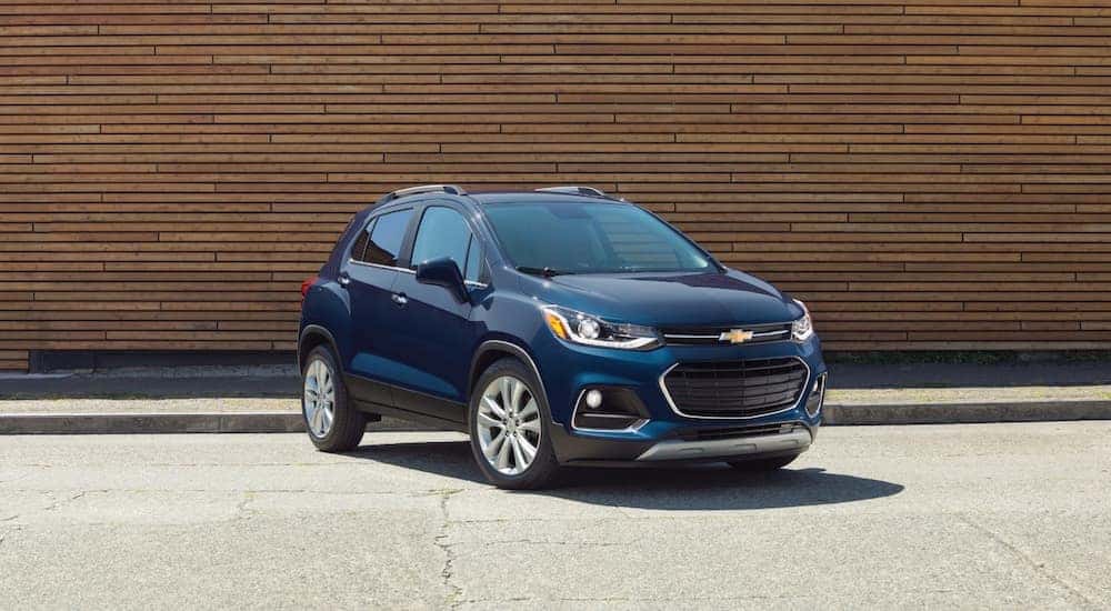 A blue 2018 Chevy Trax is shown parked near a sidewalk.