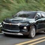 A black 2020 Chevy Blazer is shown driving to visit a used SUV dealer in Indianapolis.