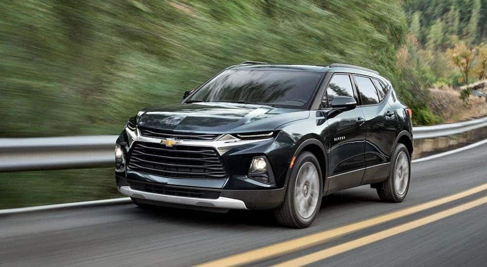 A black 2020 Chevy Blazer is shown driving to visit a used SUV dealer in Indianapolis.