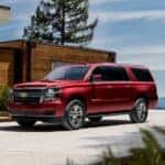 A red 2020 Chevy Suburban is parked in a driveway after leaving a used SUV dealer in Indianapolis.