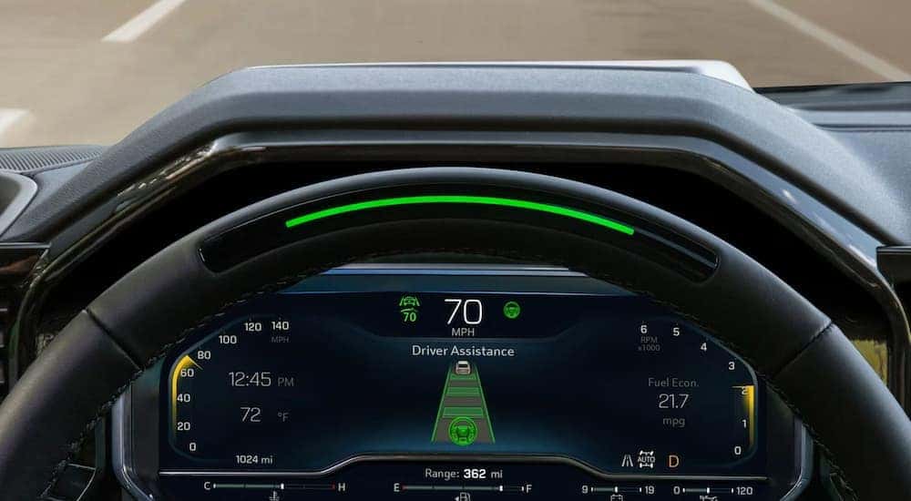 A close-up of the Super Cruise feature on the steering wheel of a 2024 Chevy Silverado 1500.