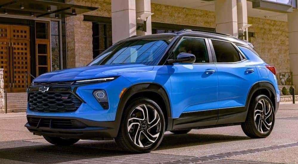A blue 2024 Chevy Trailblazer RS is shown parked on a city street.
