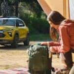 A yellow 2024 Chevy Trailblazer ACTIV is shown parked near a tent.
